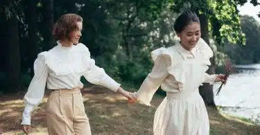 Women in Old-Fashioned Clothing Holding Hands in Park