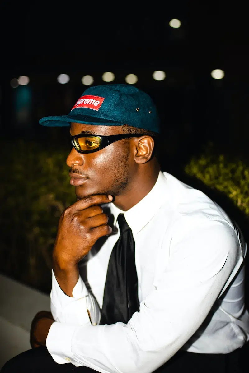 Man in White Dress Shirt and Blue and White Fitted Cap